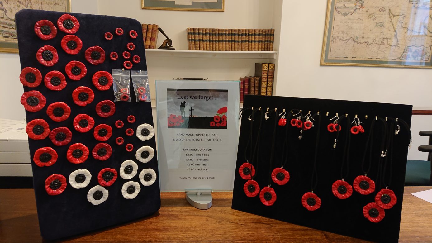 Poppy badges and ear rings for sale in reception